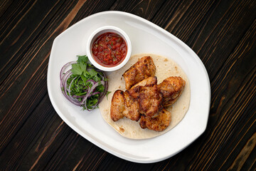 Shish kebab with barbecue sauce on a plate, with a small depth of field