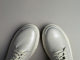 beige women's shoes on a gray background. Autumn shoes. Horizontal image