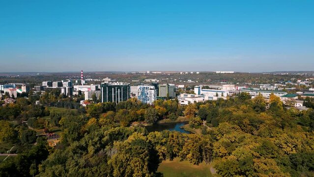 Aerial drone flyover Dendrarium Park and lake in the capital of Chisinau, Republic of Moldova - bird view flight towards the Strada Calea Iesilor in the center of the capital 2022