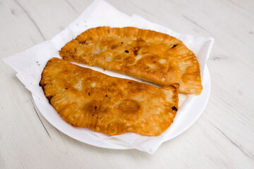 Pie with potatoes and onions. Fried dough pie.