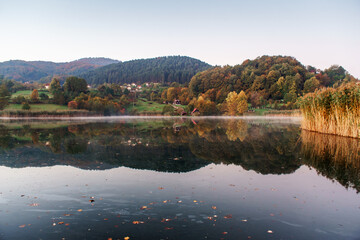 autumn color on the lake, beautiful yellow-red with reflection on the water