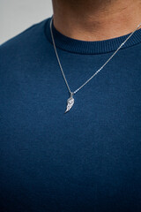 Silver necklace on blue background jewelry fashion 