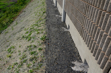 freeway bridge drainage. A sound-absorbing wall with holes lets water through. gutters collect...