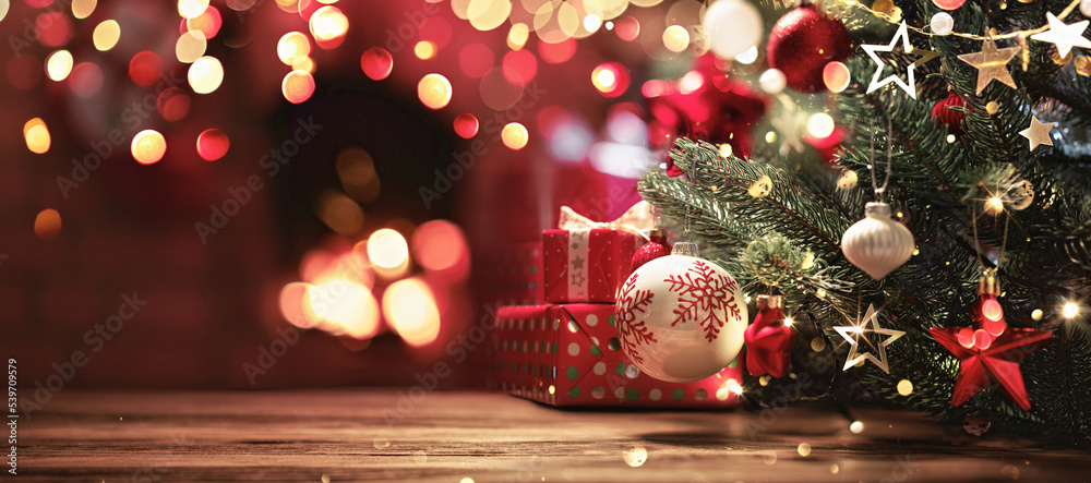 Wall mural christmas tree with decorations near a fireplace with lights