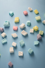 Light blue background with marshmellow color sweet food