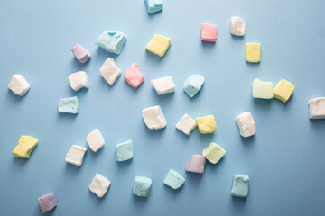 Light blue background with marshmellow color sweet food top view
