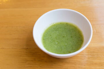 Thai seafood dipping sauce in a white cup.
