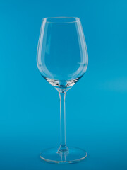 Empty wine glass on a blue background.