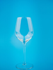 Empty wine glass on a blue background.