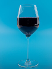 A glass of wine on a blue background.