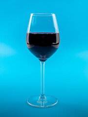 A glass of wine on a blue background.