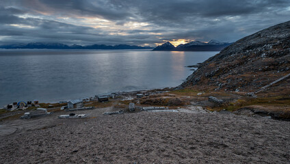The Arctic Ocean and the Byam Martin Mountains with sleds and huts on the coast of Baffin Island