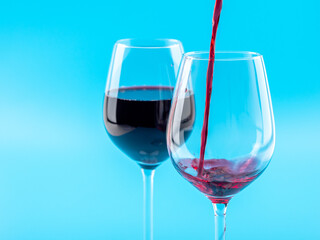 A glass of wine on a blue background.