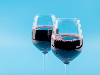 A glass of wine on a blue background.