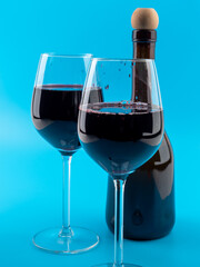 A glass of wine on a blue background.