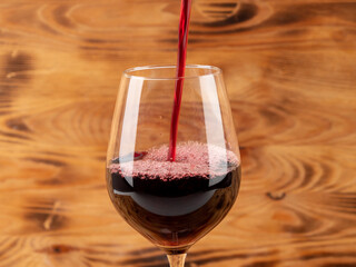 Glass of wine on a wooden background.