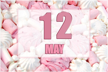 calendar date on the background of white and pink marshmallows. May 12 is the twelfth day of the month