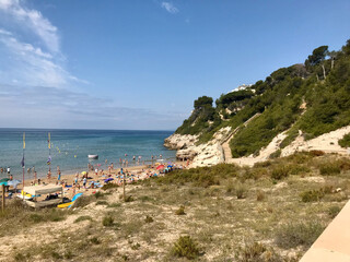 Salou, Spain, June 2019 - A group of people sitting at a beach