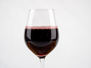 A glass of wine on a white background.