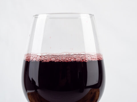 A glass of wine on a white background.