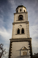 Fototapeta na wymiar Low angle view of the church bell tower, Samokov, Bulgaria. Dramatic sky in the background