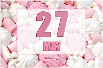 calendar date on the background of white and pink marshmallows. May 27 is the twenty-seventh day of...