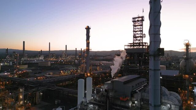 Shell Refinery polluting the air while manufacturing gasoline at dusk, Martinez California