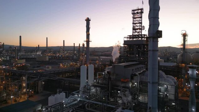 Refinery producing Gasoline as smoke pollutes the air at dusk, Shell Refinery, Martinez California