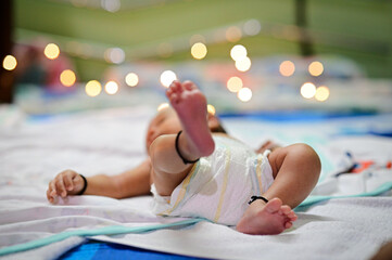 Small legs of baby and lovely lights. Baby comfort and relax. Black Thread for Protection From Black eyes. Indian Baby