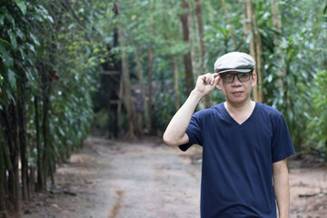 Obraz premium Portrait of a man enjoying walking in the woods agritourism, Slow life concept, vacation lifestyle alone.