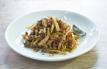 spicy stir fried bamboo shoot and chop beef meat with basil leaf on plate 