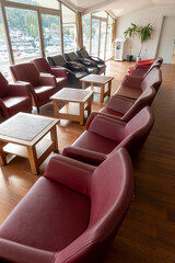 Stylish red chairs. Rows of red chairs arranged in the main conference room.
