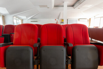Obraz premium Stylish red chairs. Rows of red chairs arranged in the main conference room. 