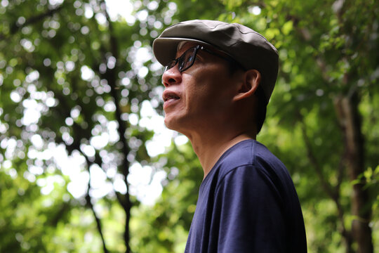 Portrait of a man enjoying walking in the woods agritourism, Slow life concept, vacation lifestyle alone.