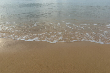 Beautiful beach with the smooth foam of sea in the morning of Rayong province Thailand