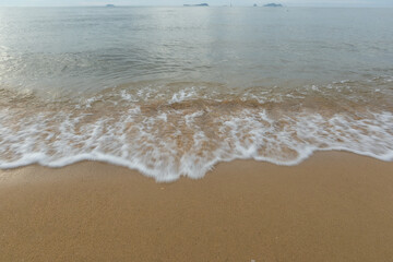 Beautiful beach with the smooth foam of sea in the morning of Rayong province Thailand
