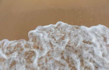 Beautiful beach with the smooth foam of sea in the morning of Rayong province Thailand