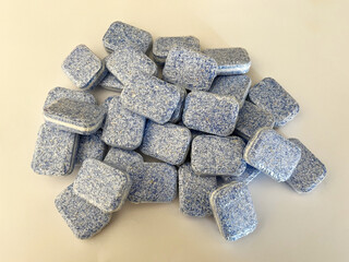 Liquid capsules for washing machine on a white insulated background. Dishwasher capsules close-up