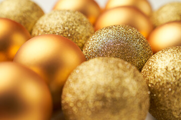 selective focus on golden Christmas balls with different textures and glitters
