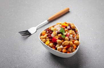 Overnight soaked legume salad of chickpea-kidney beans and other raw veggies mixed with herbs and mild spices