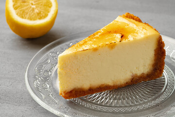 Piece of lemon cheesecake on glass dish