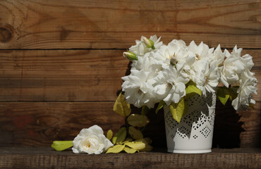 bouquet of white roses on the wooden background with copy space