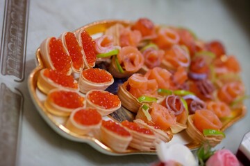 Delicious fish caviar canapes. Seafood in the diet. Decoration of the festive table.