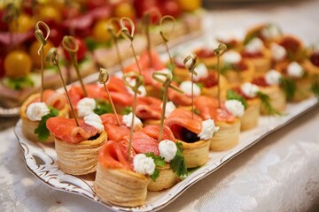 A delicacy of red fish on the festive table. Snacks for guests at the event.