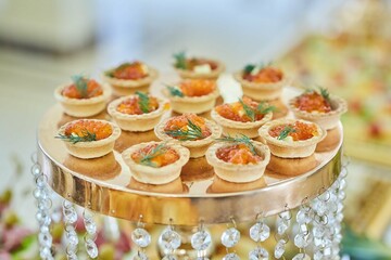 A delicacy of red fish on the festive table. Snacks for guests at the event.