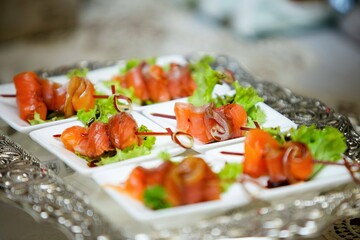 A delicacy of red fish on the festive table. Snacks for guests at the event.