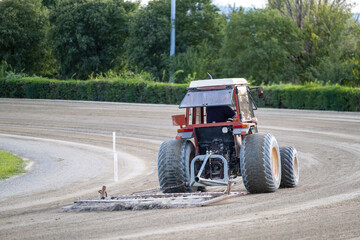 Tractor rolling the ground and preparing the field for an Equestrian competition in Italy. Tractor...