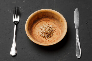 Concept of a global food crisis caused by hunger due to lack of grain. Plate with small amount of...