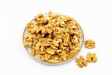 Walnut kernel in glass plate isolated on white background