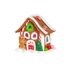 Gingerbread house toy with gingerbread man and christmas tree isolated on white background